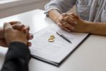 Divorce agreement and wedding rings. Divorce Process Concept