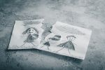 Concept of divorce, betrayal, separation and disintegration of family. Children's drawing with wedding rings.